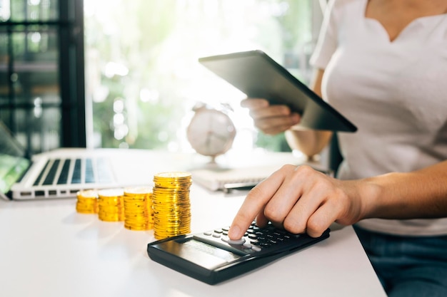 Business accounting concept Business man using calculator with computer laptop budget and loan paper in office