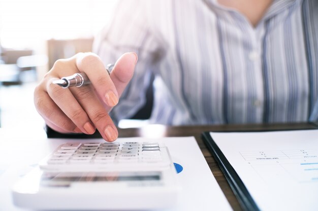 Business accounting women work with calculator and Laptop