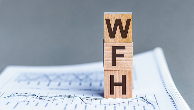 Бизнес-аббревиатура WFH как «Работа на дому» на деревянных кубиках. Концепция.