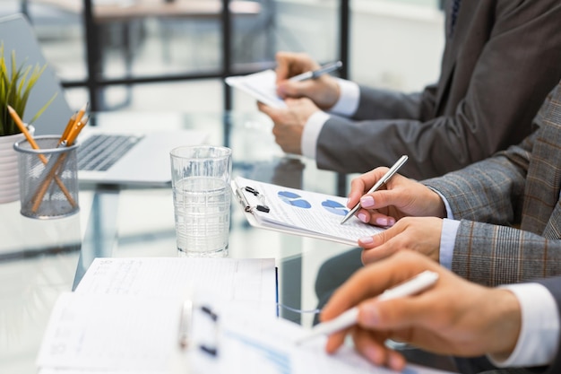 Photo business adviser analyzing financial figures denoting the progress in the work of the company