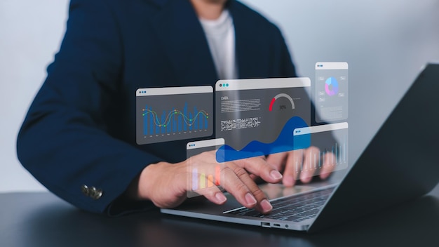 Business analytics with charts Financial and marketing strategy KPIs to improve organizational performance Businessman use computers to analyze business and manage corporate data in office