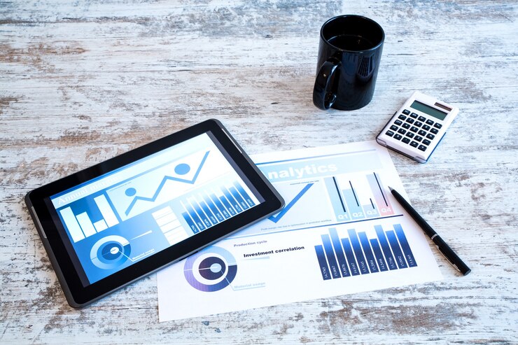 Photo business analytics on a wooden desk with a tablet pc.
