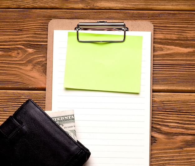 Фото Бизнес и концепция кредитования. на деревянном столе лежит пустой лист рядом с кошельком с деньгами.
