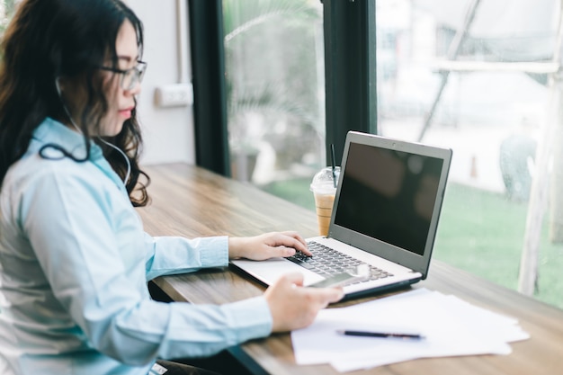 Business Asian woman be dressed in earphone working 