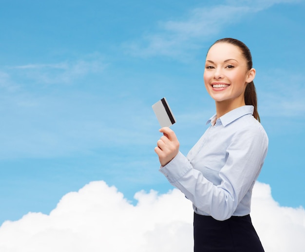 business and bank concept - smiling businesswoman showing credit card