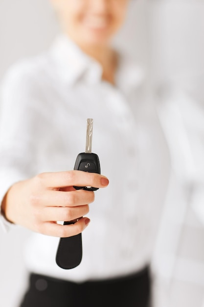 Photo business, banking, vehicle, rental, automotive concept - woman hand holding car key