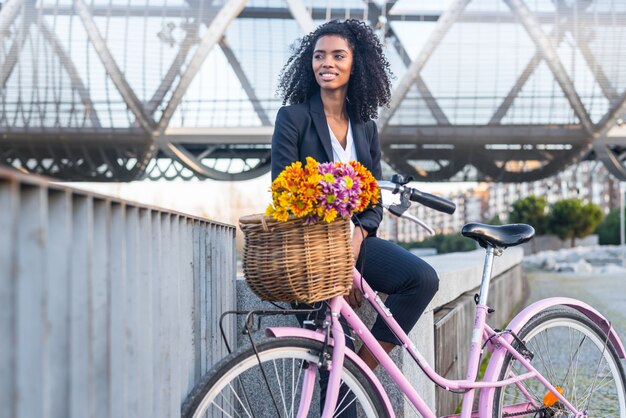 Business black woman with vintage bicycle