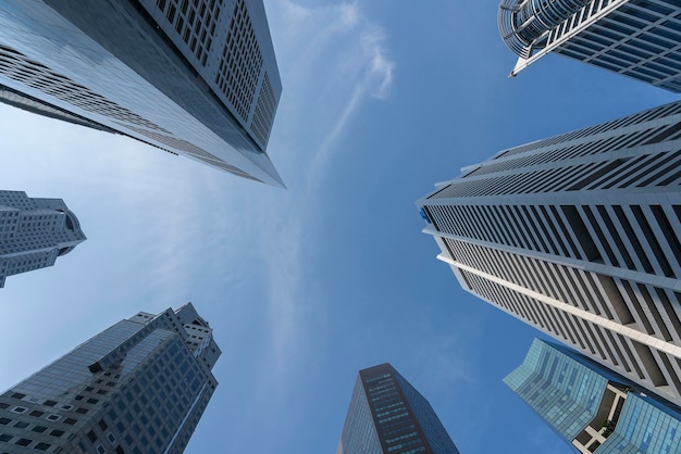 Business buildings skyline looking up with blue sky background Highrise skyscraper modern architecture