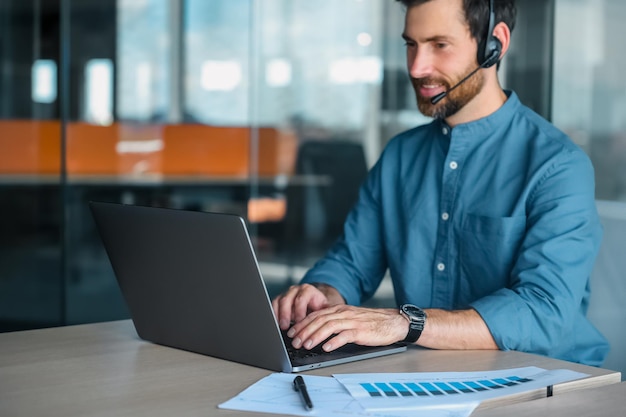 Business call. Young man in blue shirt having a business call