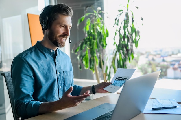 Business call. Young man in blue shirt having a business call