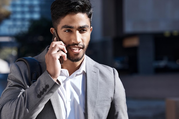 Business calls on the go Shot of a young businessman on a call in the city