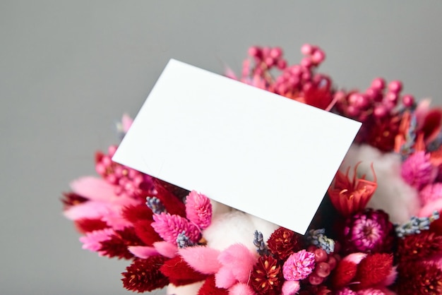 Business card or invitation mockup and dried flower bouquet closeup