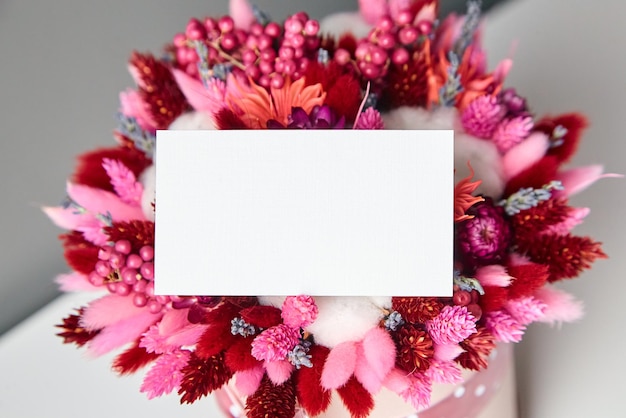 Photo business card or invitation mockup and dried flower bouquet closeup