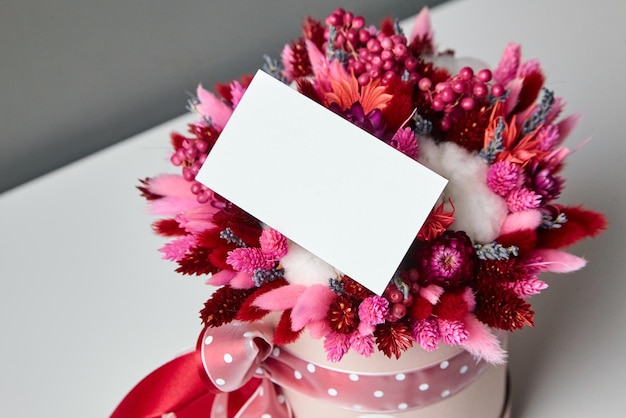 Business card or invitation mockup and dried flower bouquet closeup