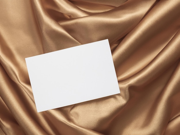 Photo business card mockup on shiny gold fabric