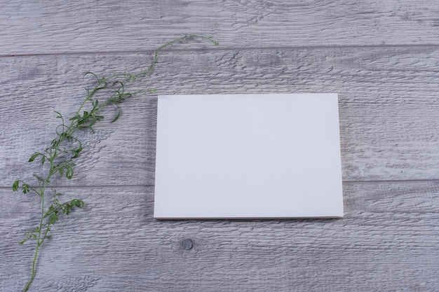 Photo business card mockup with a flowers on a table