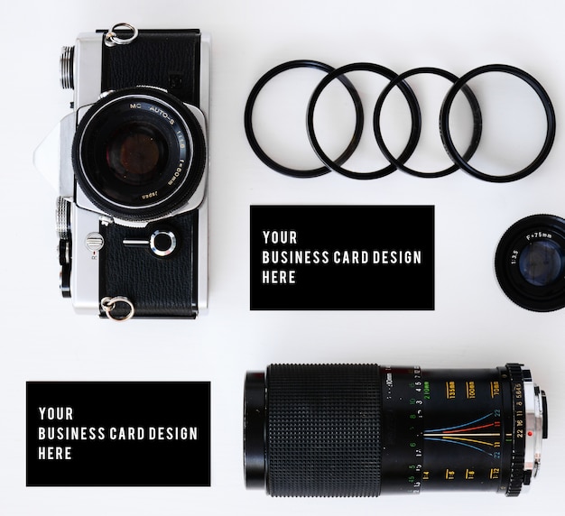 Photo business card mockup with old film camera and lenses with filters and glasses