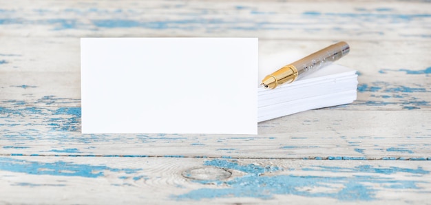 Photo business card with pen on wooden table business concept