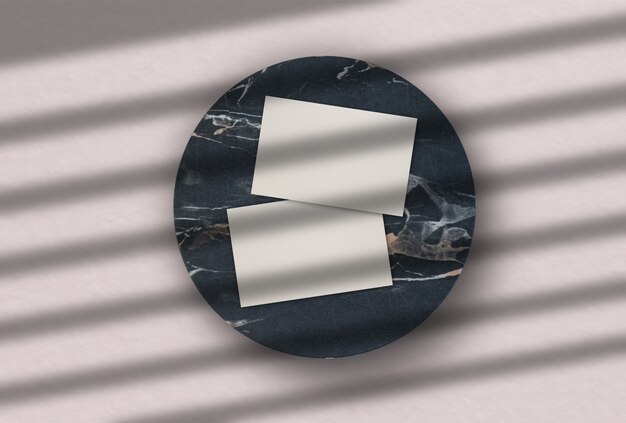 Business cards over a circle of dark marble