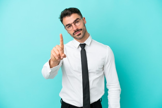 Business caucasian man isolated on blue background showing and lifting a finger