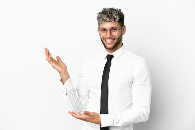 Business caucasian man isolated on white background extending hands to the side for inviting to come