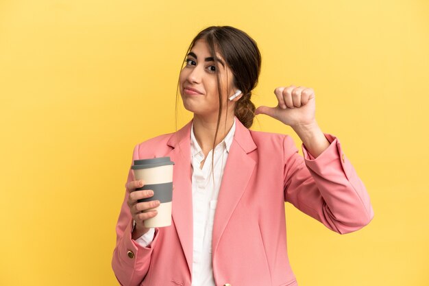 Business caucasian woman isolated on yellow background proud and self-satisfied