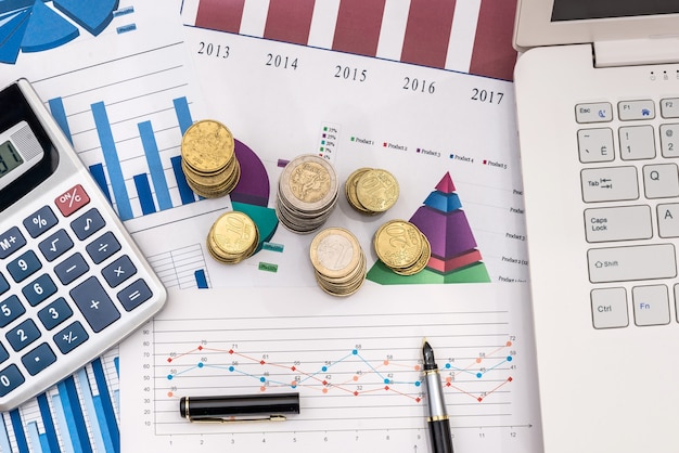 business chart with coin and laptop