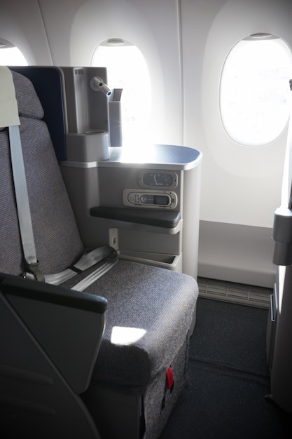 A business class clean cabin of the airplane opened portholes