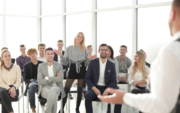 Business coach at a meeting with a group of young business
people