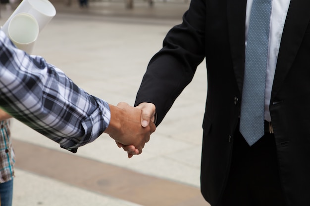 Photo business collaboration, businessmen and engineers shaking hands