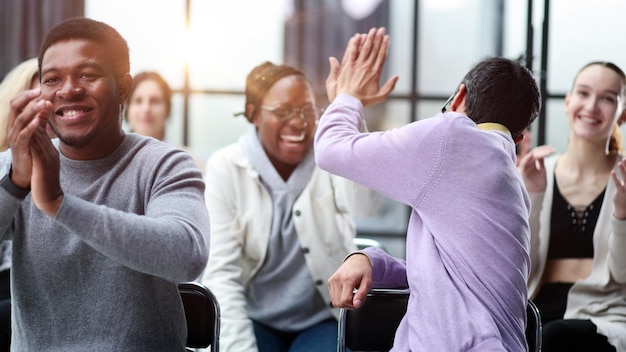 Business colleagues are sitting during a meeting shaking hands