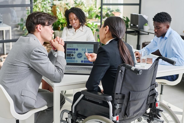 Business colleagues developing new strategy on laptop