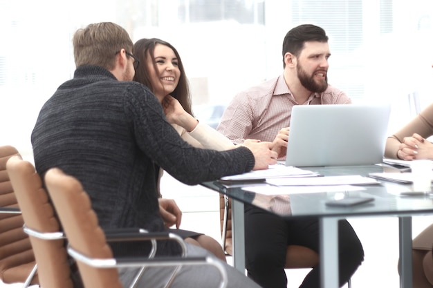 Business colleagues discuss financial data sitting at the desk