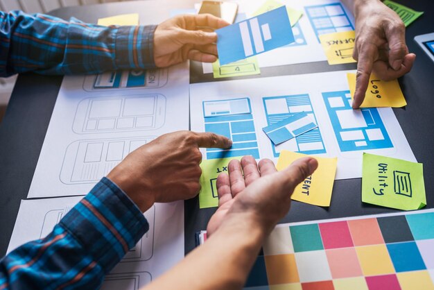 Photo business colleagues discussing paperwork on table in office