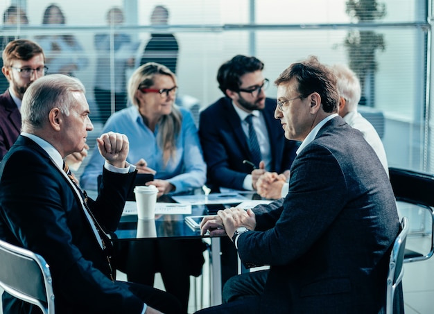 Business colleagues discussing serious issues at an office meeting