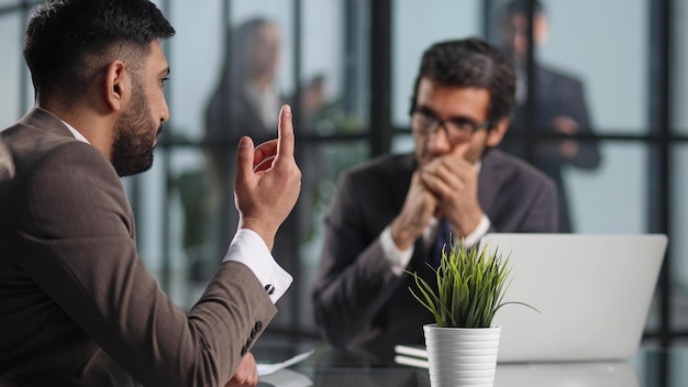 Business colleagues discussing work tasks sitting at table