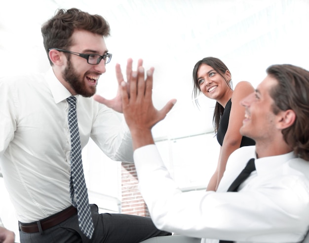 Business colleagues giving each other high five