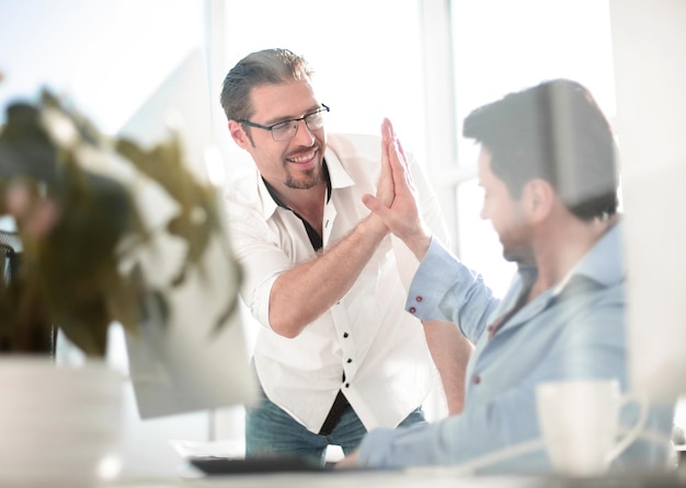 Business colleagues giving each other a high five