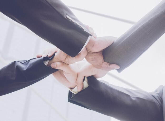 Business colleagues holding hands