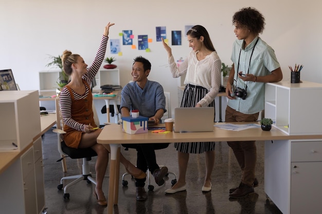 Business colleagues interacting with each other in office