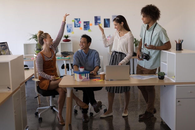 Photo business colleagues interacting with each other in office