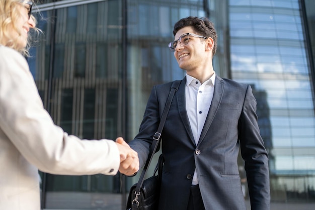 Business colleagues meet a team a woman and a man in business suits go to the office