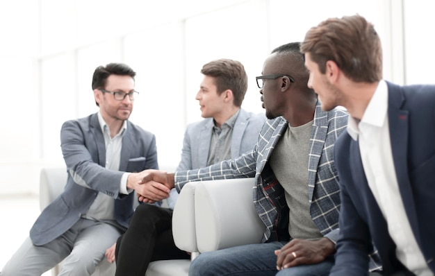 Business colleagues reaching out for a handshake