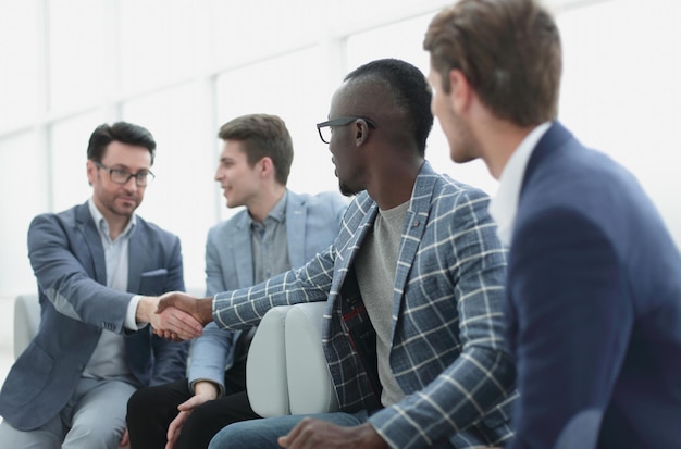 Business colleagues reaching out for a handshakethe concept of\
solidarity