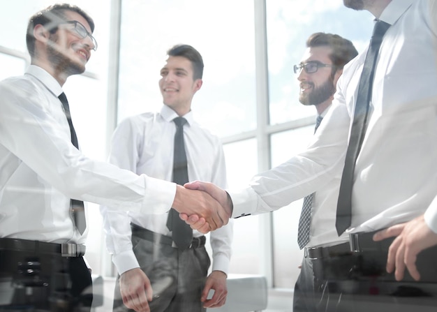 Business colleagues shaking hands in the office