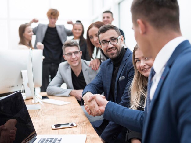 Business colleagues shaking hands at the workplace