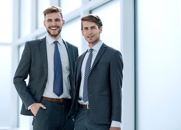 Business colleagues standing in a bright office