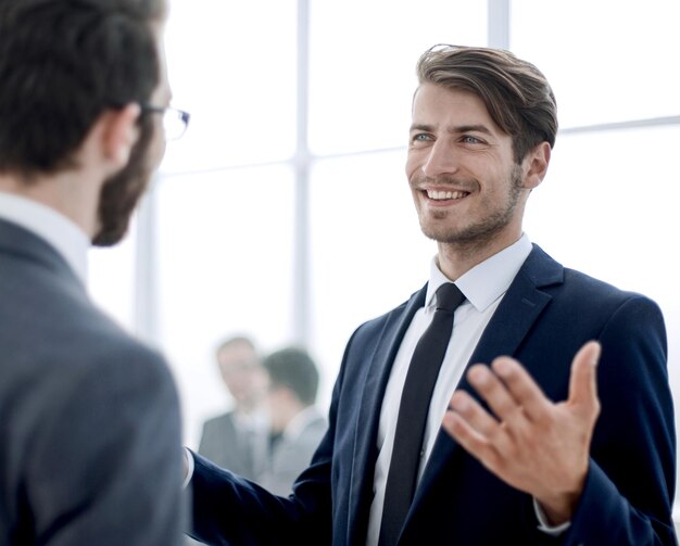 Business colleagues talking standing in the lobby of the business centeroffice weekdays