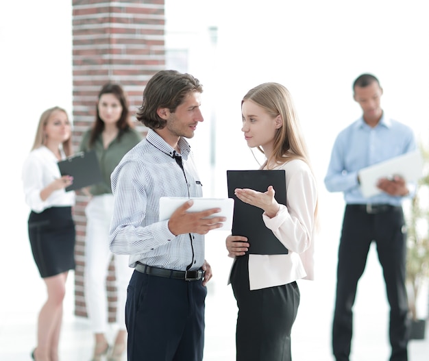 Business colleagues talking, standing in a modern office.the concept of cooperation