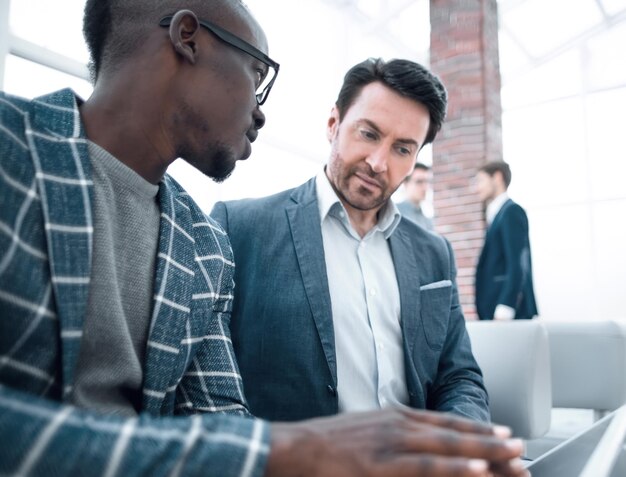 Business colleagues use a digital tablet to view information